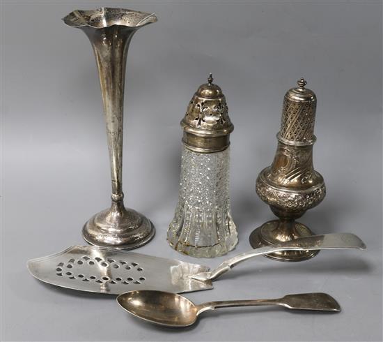 A George III silver fish slice, an engraved and embossed silver sugar caster and three other items,